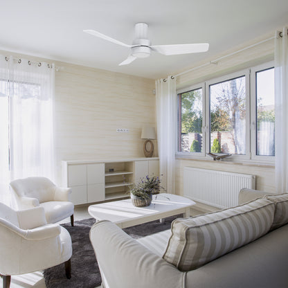 A modern and minimalist living room featuring the Barnet 44-inch flush mount smart ceiling fan in a sleek white finish. The fan has three blades and an integrated LED light, providing both illumination and air circulation. Controlled via remote, it seamlessly blends with the bright and airy decor of the space. 
