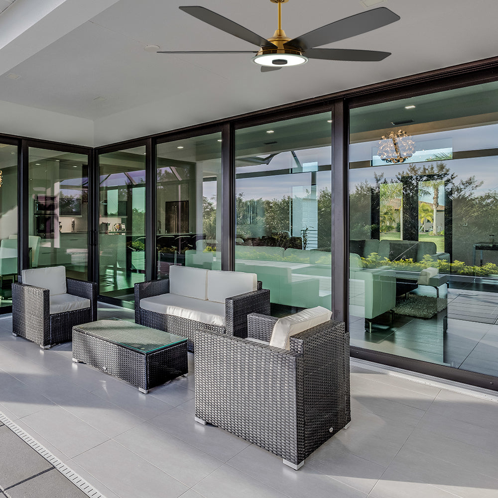 Carro Striker 56 inch outdoor ceiling fan with black and gold design, installed in outdoor patio. 